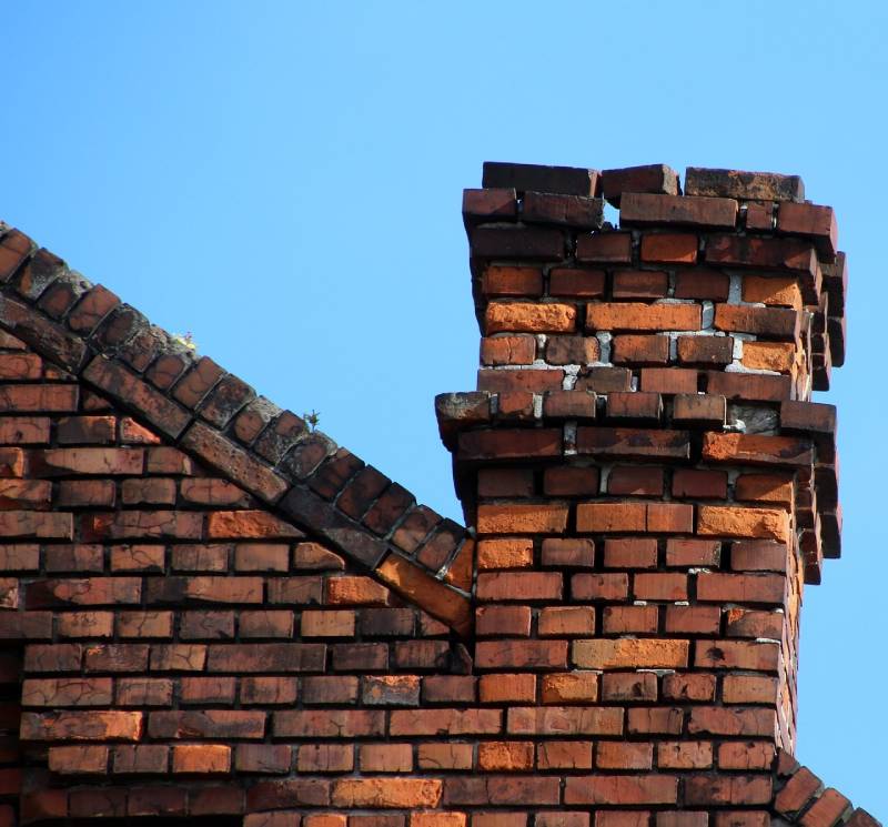 Damaged chimney on an River Rouge home showing cracks and missing mortar